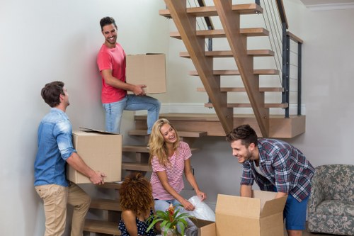 Professional flat removals in Oldmalden with movers loading a van