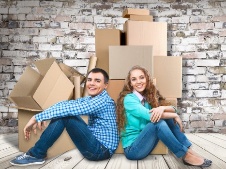 Movers unloading boxes and furniture at a new property in Oldmalden